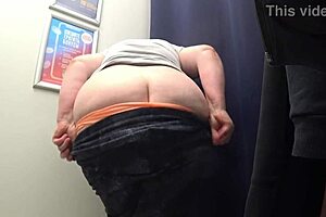 Big-ass curvy milf changes clothes in satin panties, watched by the fitting room camera in this amateur fetish.