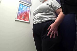 Big-ass curvy milf changes clothes in satin panties, watched by the fitting room camera in this amateur fetish.