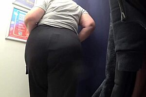 Big-ass curvy milf changes clothes in satin panties, watched by the fitting room camera in this amateur fetish.