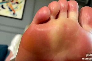 This goddess lazily teases with pink oily soles and toes in closeup