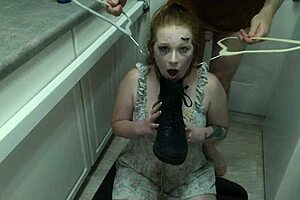 enthusiastic redhead slut licks cum from boot in bdsm humiliation