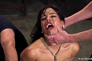 Latina slave feels rough pleasure in bondage threesome.