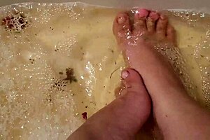 washing tattooed feet with rose petals and herbs after work