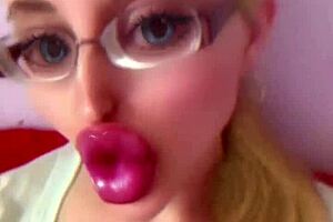 Dollification sissification ramps up with huge pink lips transformation in this bimbo fetish crossdressing session with glasses and lipstick