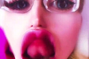 Dollification sissification ramps up with huge pink lips transformation in this bimbo fetish crossdressing session with glasses and lipstick