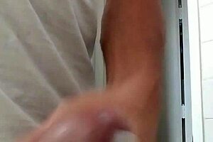 A guy strokes his cock until he cums.