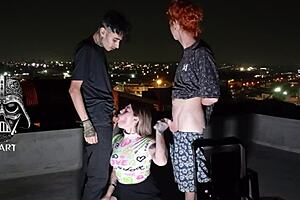 Young Girl Giving To Two Gifted Men On The Roof