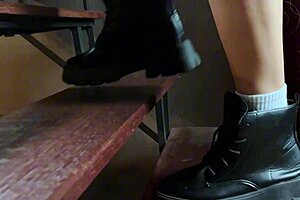 Blonde teen walks over naked body in boots