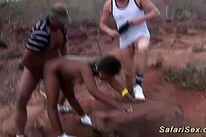 African babe engages in threesome fuck orgy outdoors