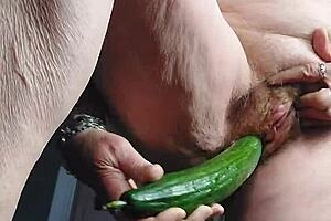 blonde granny fucks her old hairy pussy with a big cucumber!