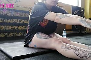 Alternative girl stretching at the gym