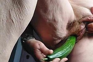 blonde granny fucks her old hairy pussy with a big cucumber!