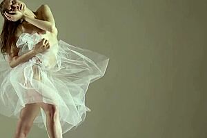 blonde gymnast stretches and performs in the gym