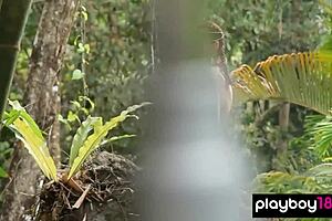 Inked teen Elizabeth Marxs showing her massive tits in a tropical forest!