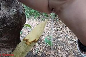 Watch this perverted slut squirt piss from a wooden stake in the forest?