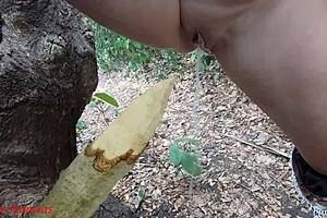 Watch this perverted slut squirt piss from a wooden stake in the forest?