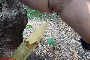 Watch this perverted slut squirt piss from a wooden stake in the forest?