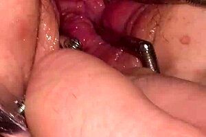 Fist Queen Endures Intense Pussy Stretching with Metal Ring in Extreme Session