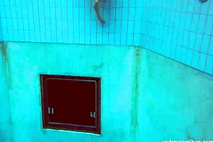 hot deniska strips underwater in the pool, her shaved body glistening naked