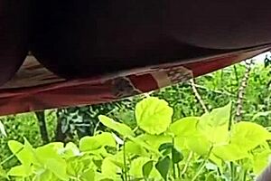 A married woman pees outdoors in public