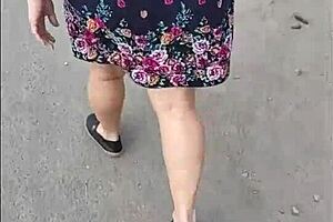 Following mature woman in skirt and thong on street