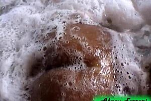 naughty brunette flaunts her stuff at the bar then strips bare in the tub!