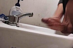 skinny solo dude rests balls on sink for monster cumshot