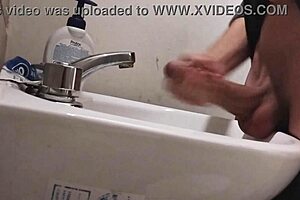 skinny solo dude rests balls on sink for monster cumshot