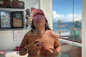 Exhibitionist slut flashes big pussy and ass in skimpy bikini on apartment balcony