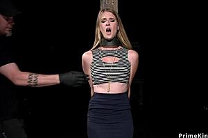 blonde slave bound by neck and hands to column endures whipping and toys