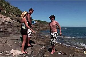 exhibitionist blonde takes double penetration in tight holes on beach