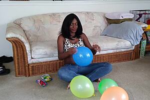ebony babe with big tits blows up balloons in french fetish play session