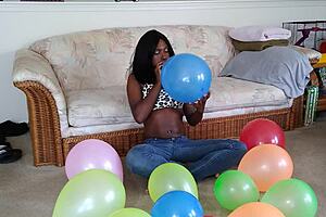 ebony babe with big tits blows up balloons in french fetish play session