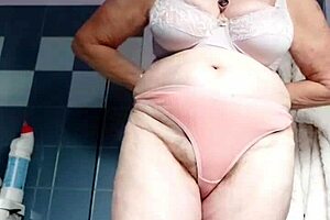 german granny slips cucumber into her hairy beaver