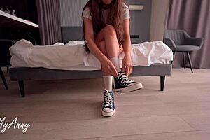 a curly-haired model slips into sneakers for a fetish creampie thrill with feet focus