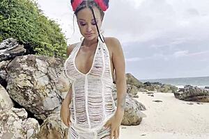 Monika Fox pleasures shaved pussy with dildo on sunny beach