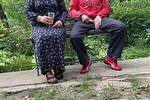 milf jerks huge cock into glass on park bench