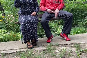 milf jerks huge cock into glass on park bench