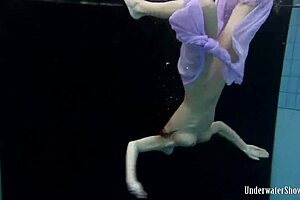 Aneta’s Big Tits Burst from Purple Dress in Pool