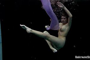 Aneta’s Big Tits Burst from Purple Dress in Pool